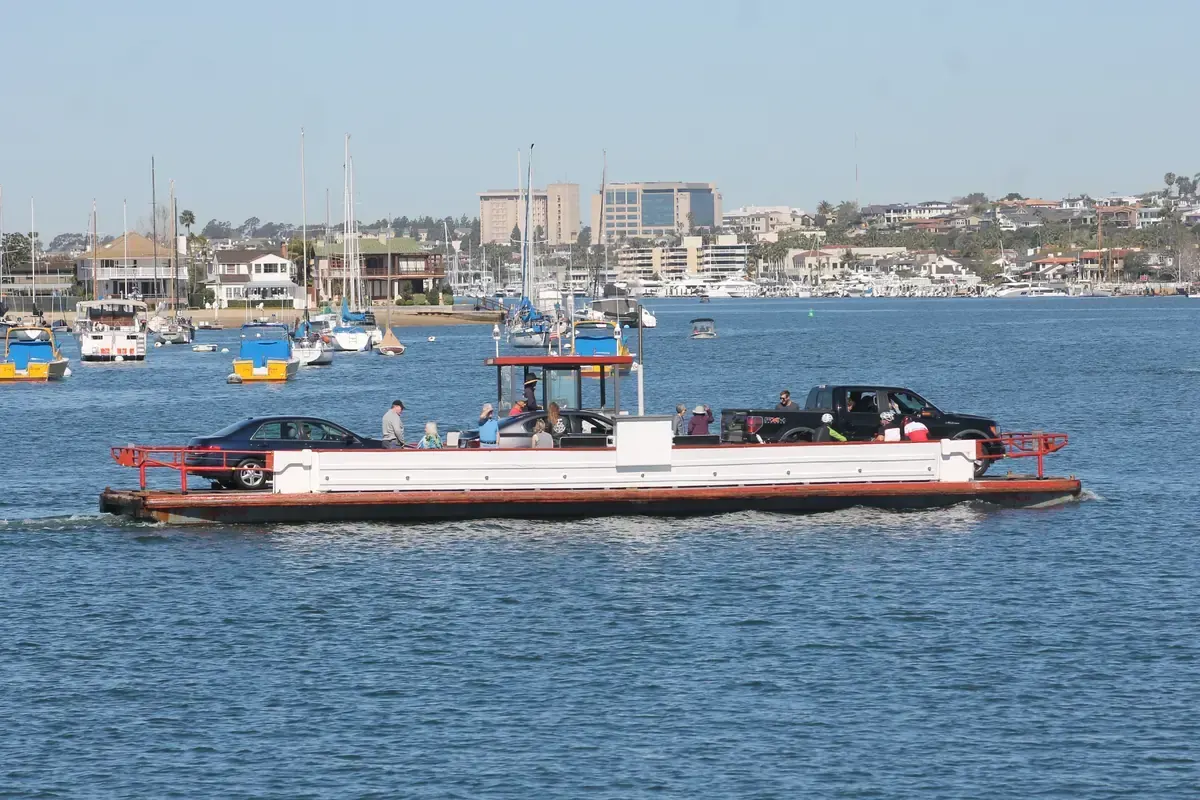 The Balboa Island Ferry carrying cars across the channel to Balboa Island in Newport Beach CA