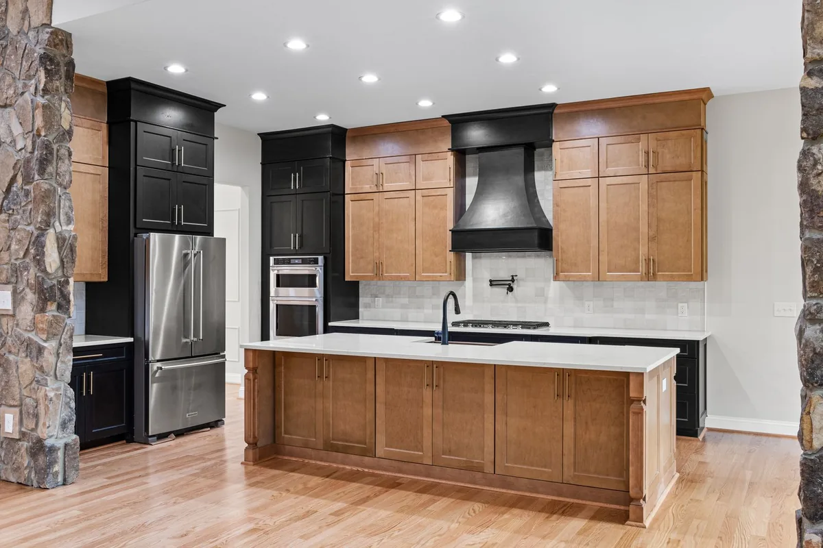 Two-tone stained and painted kitchen cabinets with a large panelled island in a Newport Beach CA home